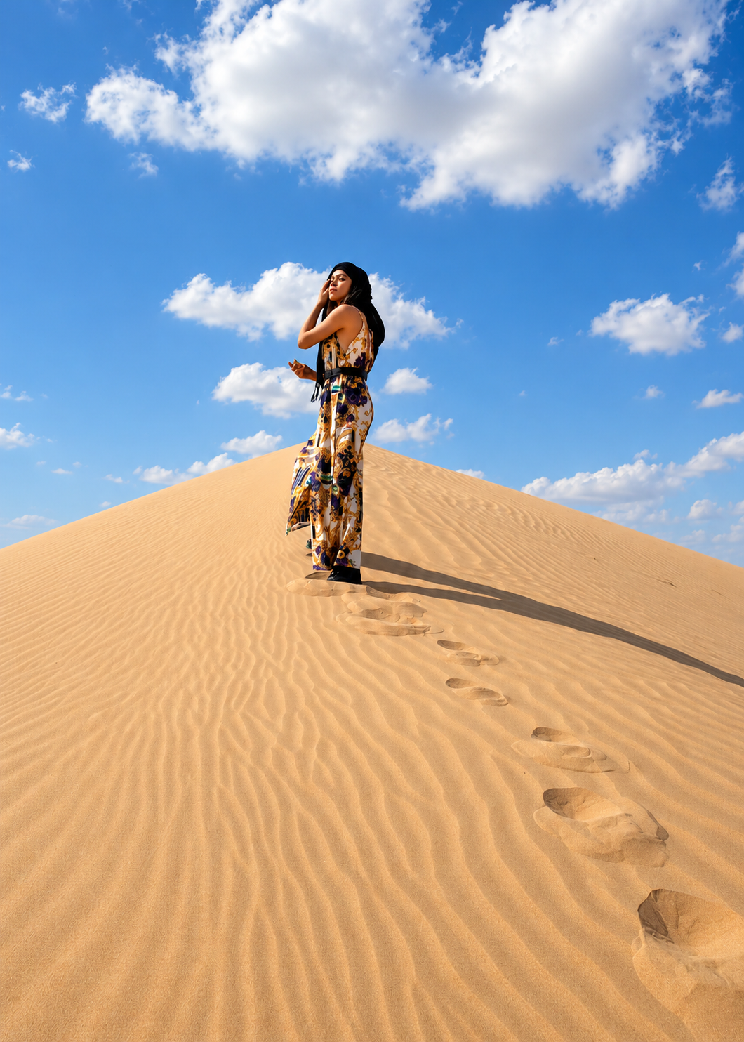 Rosi Ross posing on golden sand dunes at Al Marmoom Desert in Dubai, UAE, surrounded by expansive sandy landscapes and warm natural desert light in a contemporary travel fashion portrait.