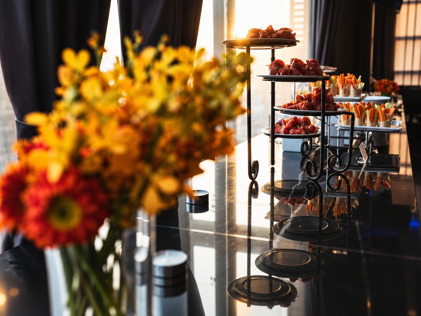 Fashion night event featuring floral arrangements, desserts, and elegant styling as part of an intimate fashion experience.