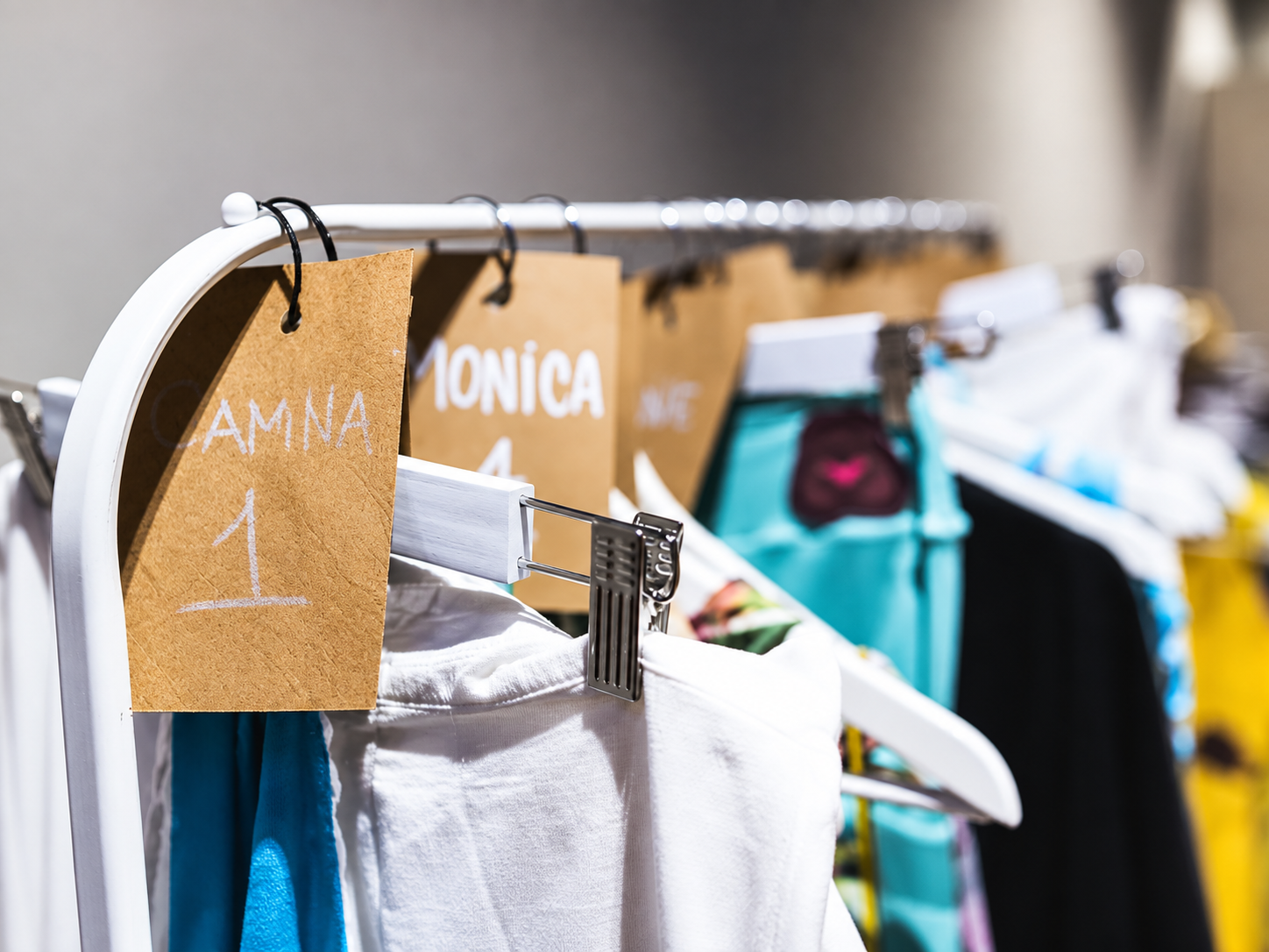 Fashion night clothing rack featuring designer garments, personalized styling details, and behind-the-scenes fashion preparation.