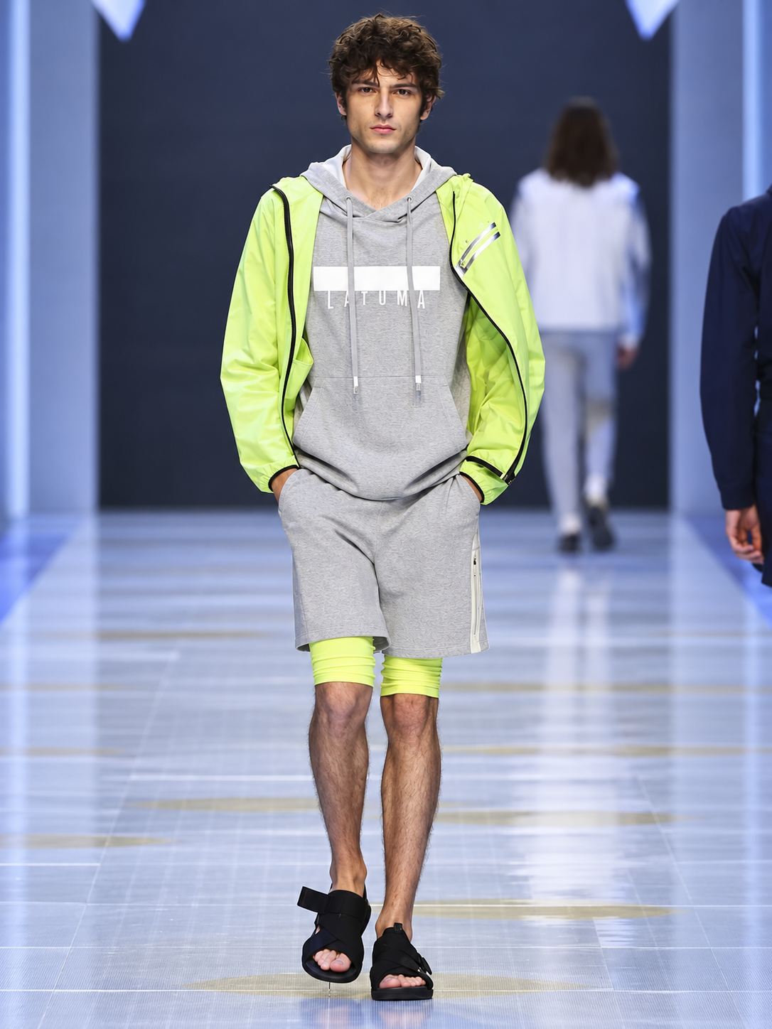 Grey and neon technical sportswear look presented during the Lafuma runway show at Shanghai Fashion Week.