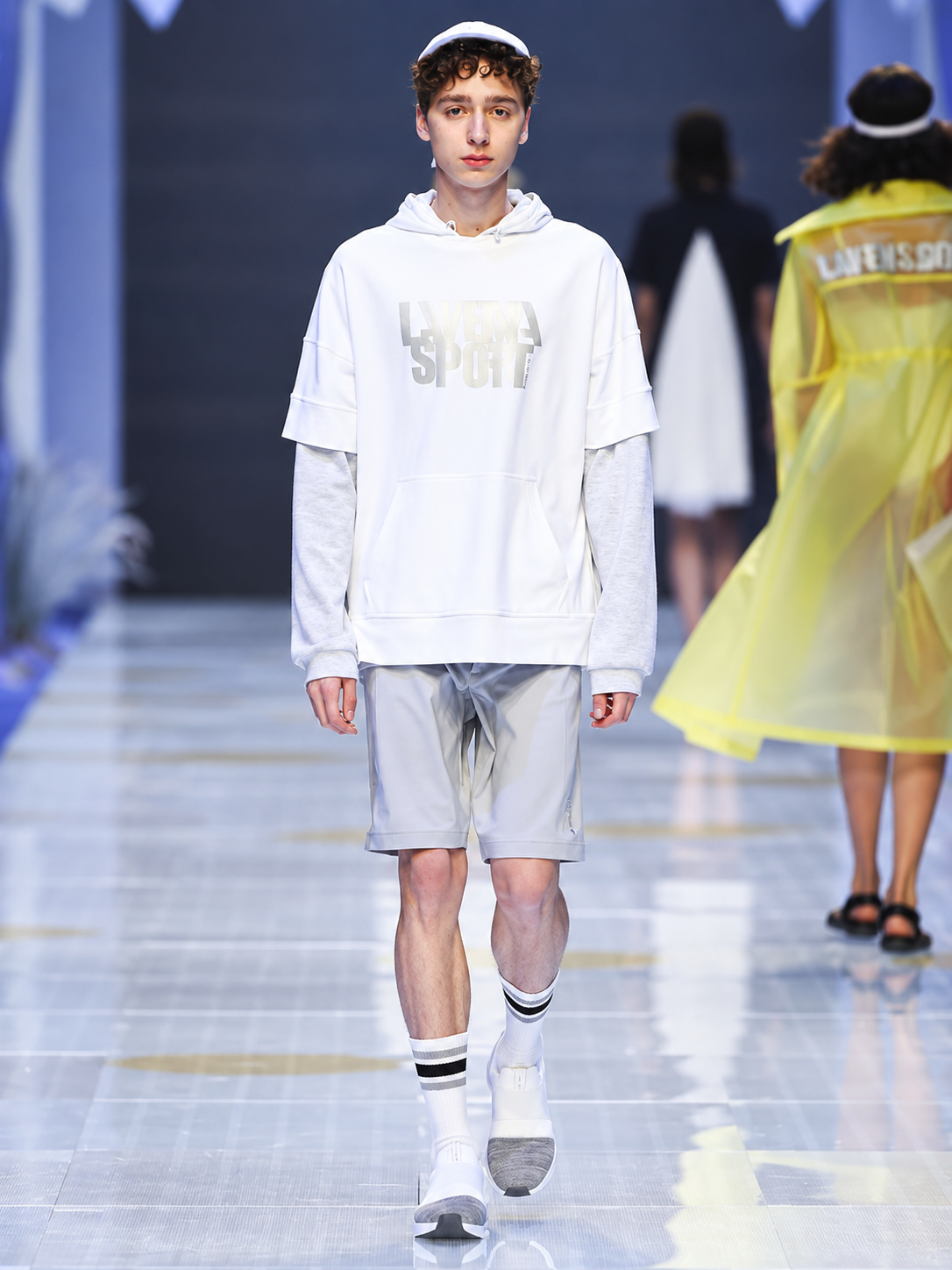 Layered white and grey menswear look presented during the Lafuma runway show at Shanghai Fashion Week.