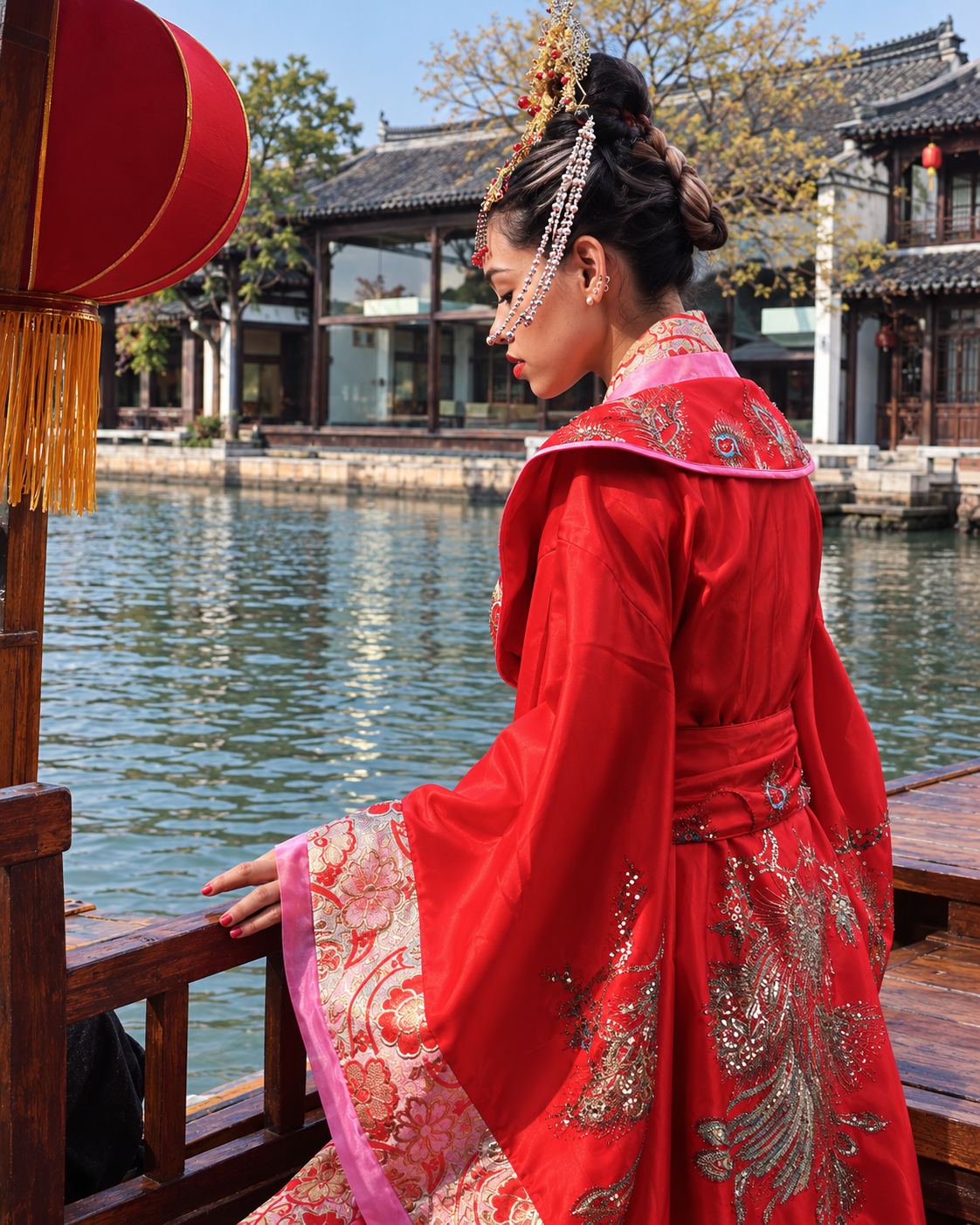 Rosi Ross wearing embroidered red Hanfu beside a traditional Chinese garden lake and architecture.