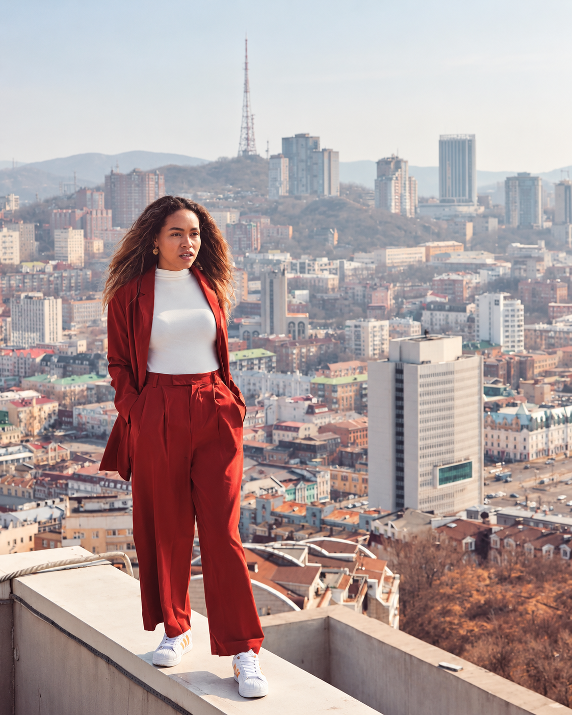 Rosi Ross wearing Adidas streetwear on a rooftop overlooking the Vladivostok skyline in Russia.