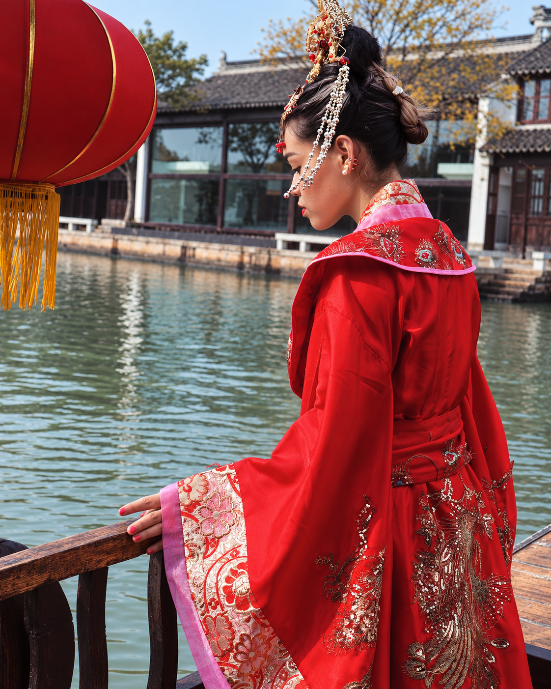Rosi Ross wearing red embroidered Hanfu in a Chinese garden, showcasing traditional Chinese fashion and craftsmanship.
