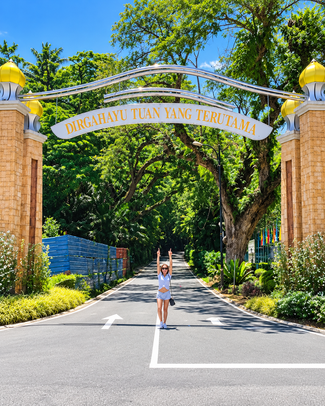 Rosi Ross exploring a tropical landmark surrounded by lush greenery during her trip through Sabah, Malaysian Borneo.