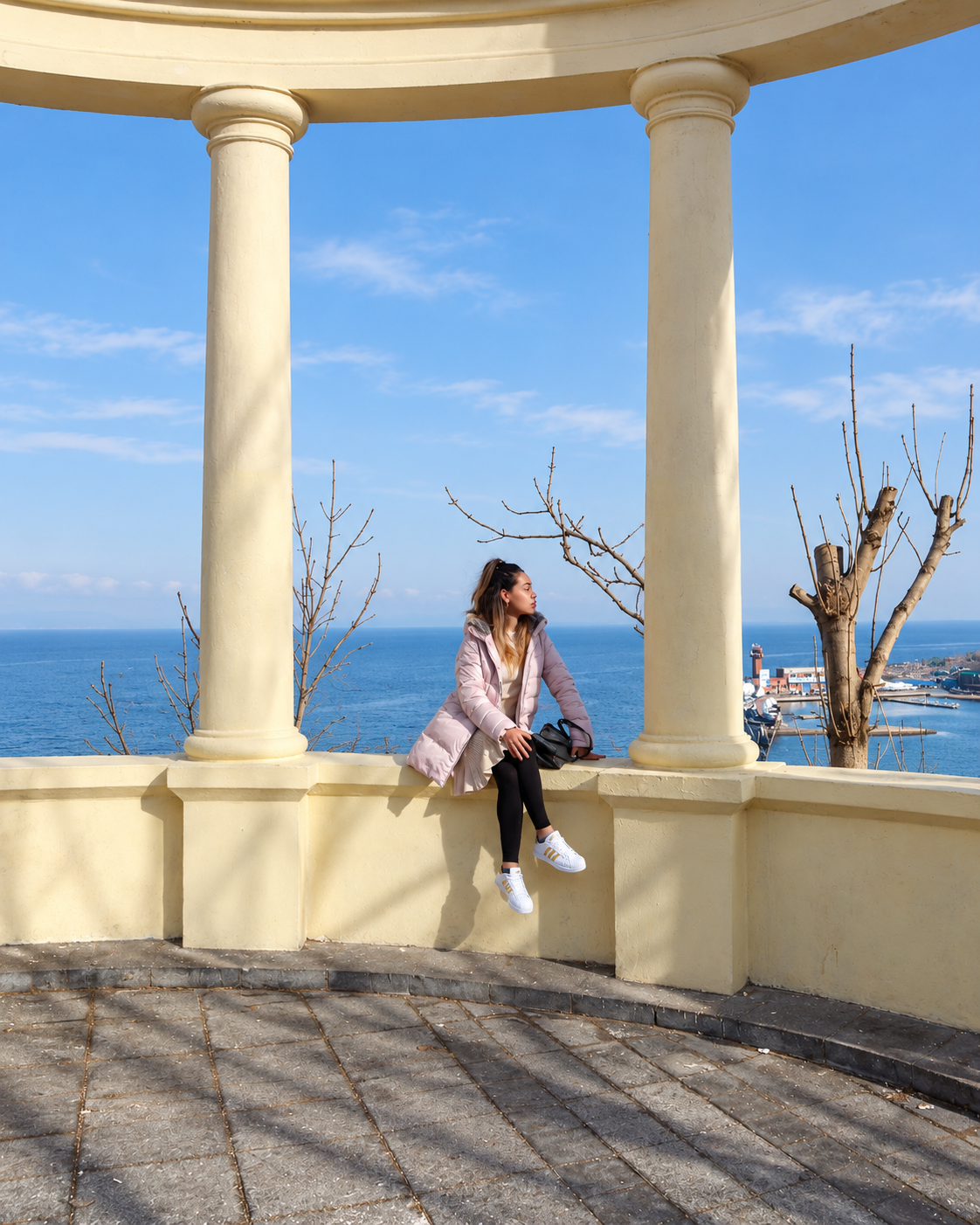 Rosi Ross at Eagle&rsquo;s Nest Hill in Vladivostok, Russia, overlooking the city, Golden Horn Bay, and surrounding urban landscape.