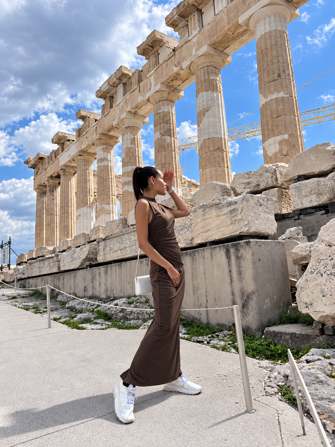 Rosi Ross visiting the Parthenon at the Acropolis of Athens, surrounded by ancient Greek columns and ruins.