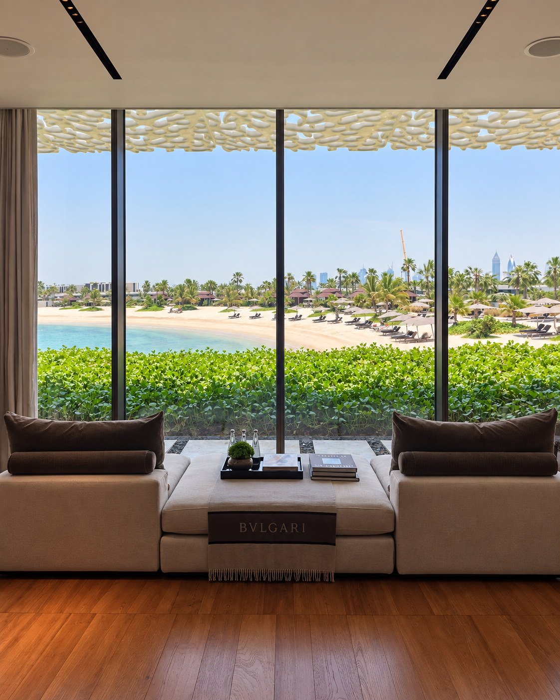 Beach and Arabian Gulf view from Bulgari Resort Dubai framed by floor-to-ceiling windows.