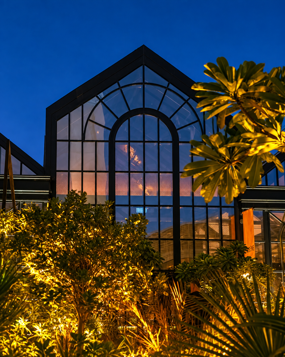 Illuminated Glass Structure at Eugene Eugene Illuminated Eugene Eugene with large glass windows and trees at dusk