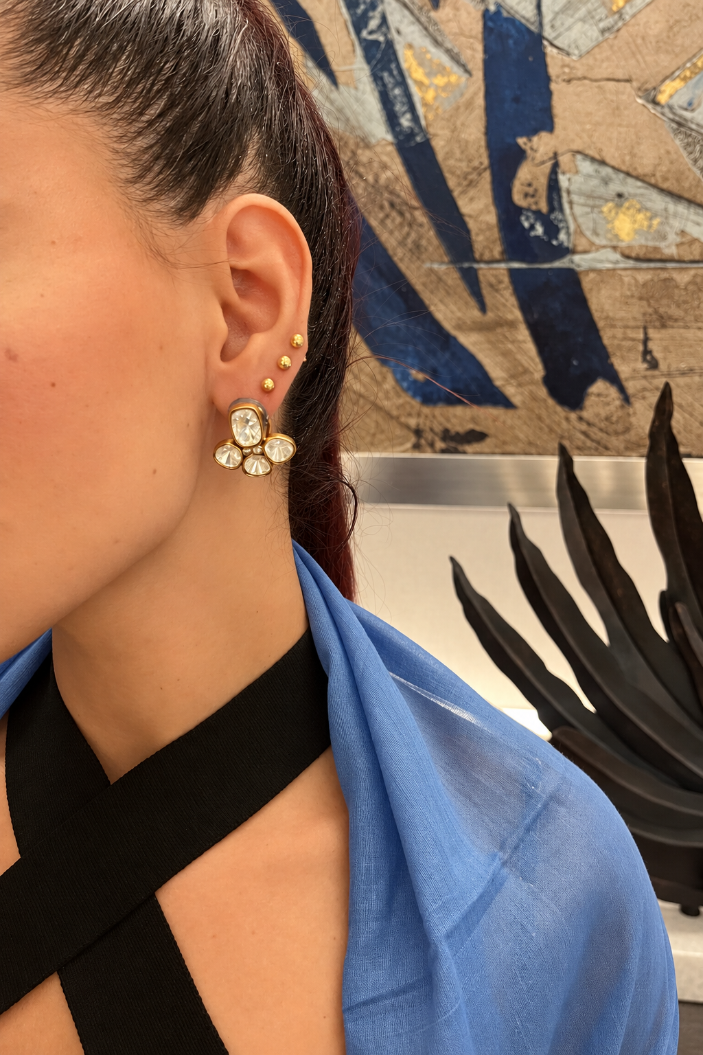 Rosi Ross Elegant Tiramisu Earrings Styling Close-up of Rosi Ross ear with styled Tiramisu earrings and multiple gold ear piercings.