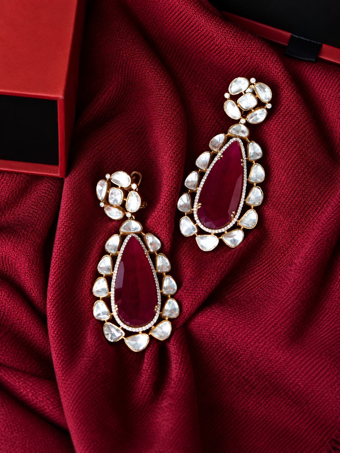 Luxurious Ruby and Diamond Teardrop Earrings from Tiramisu Close-up of elegant glass earrings with red gemstones from Tiramisu