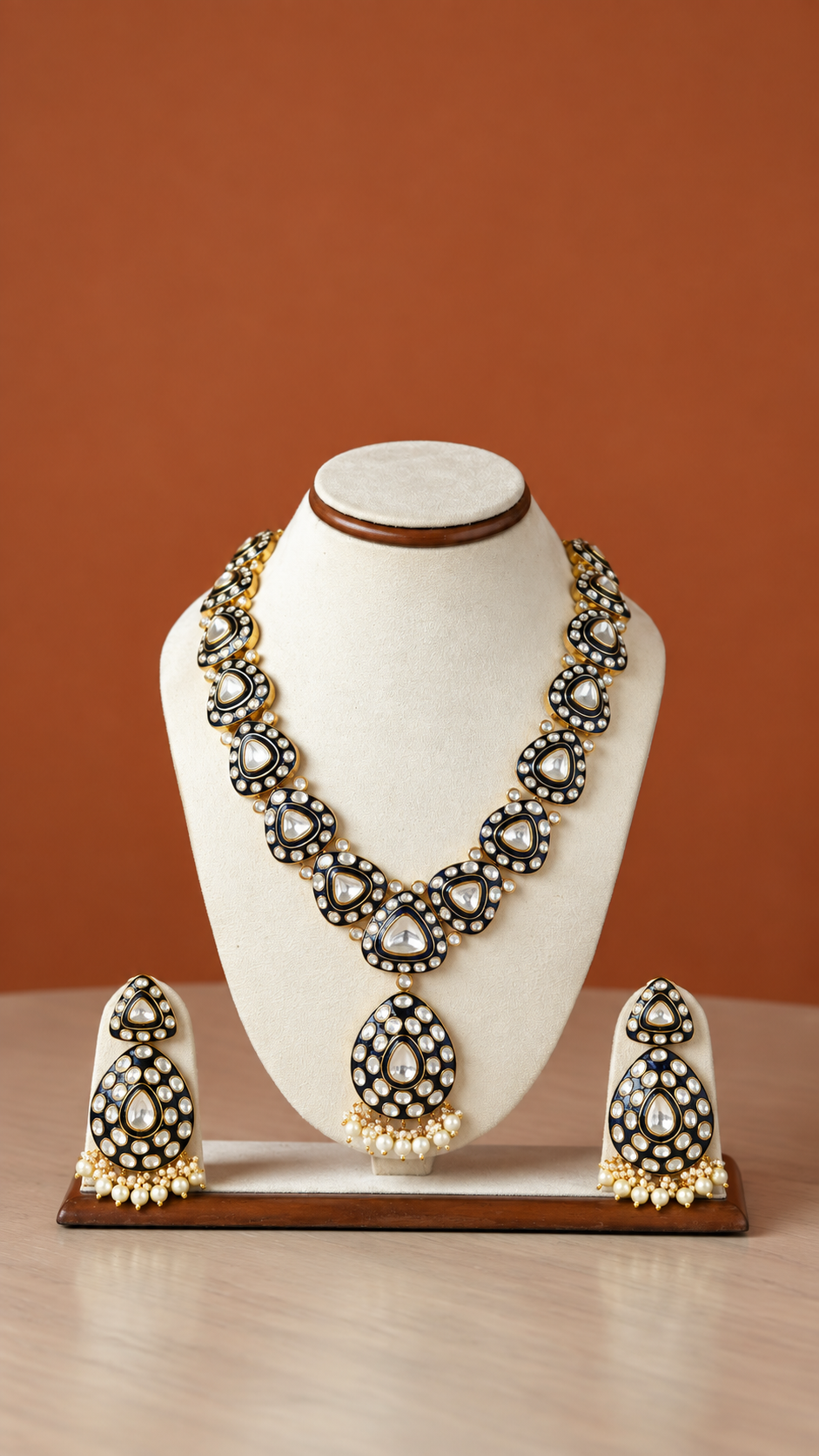 Elegant Gold and Black Necklace Set from Tiramisu Elegant gold and pearl necklace set on a bust display with matching earrings from Tiramisu