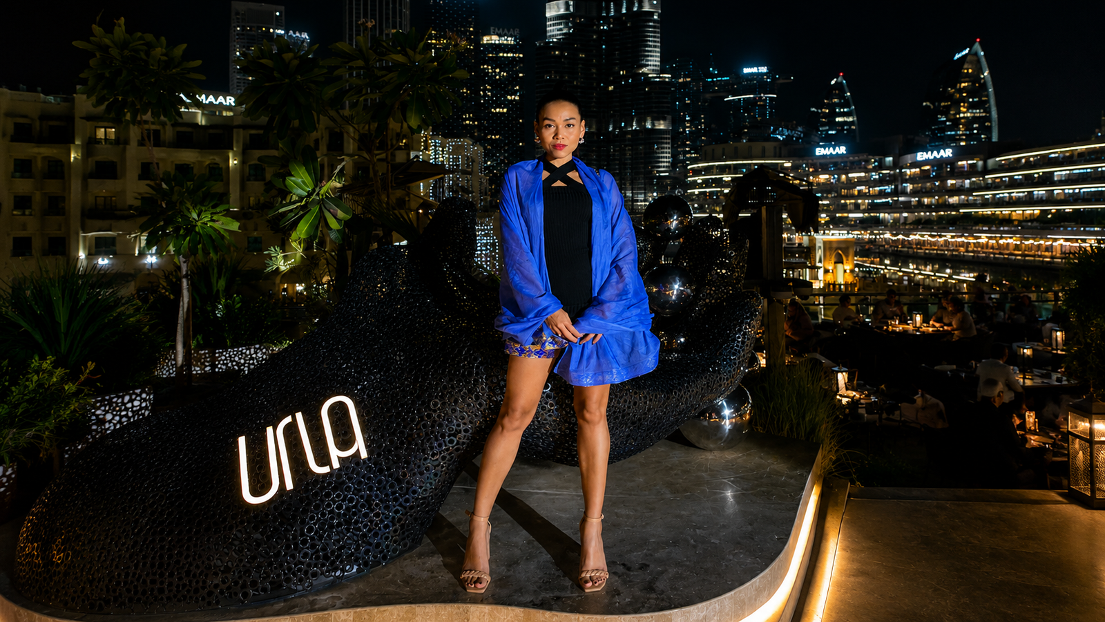 Rosi Ross editorial banner about URLA Dubai, Aegean restaurant dining, Burj Khalifa views, Mediterranean cuisine, Spanish Greek and Turkish influences, art, and experiential hospitality.