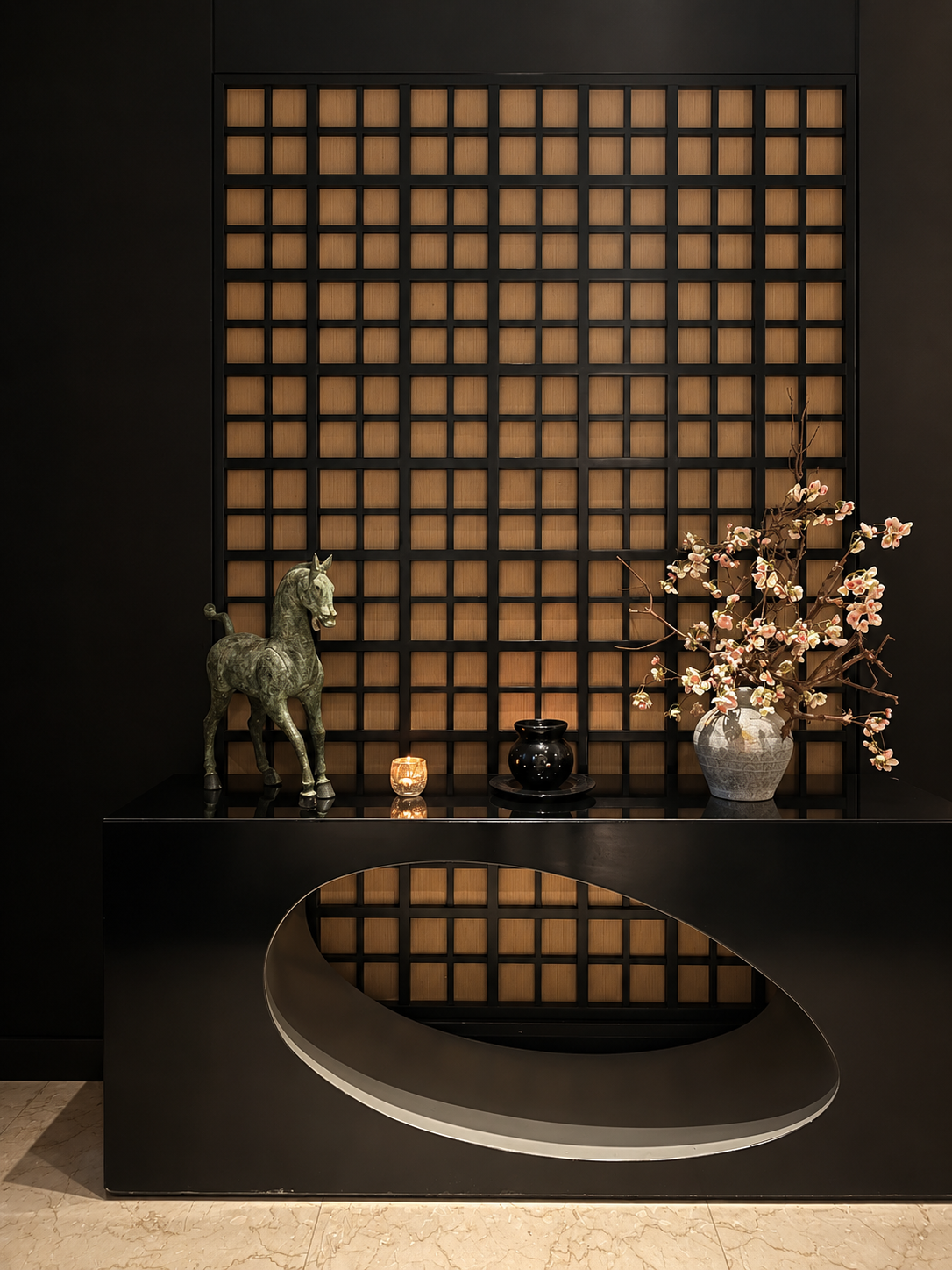 Elegant display with statue and floral arrangement on black shelf at Fairmont Nile City