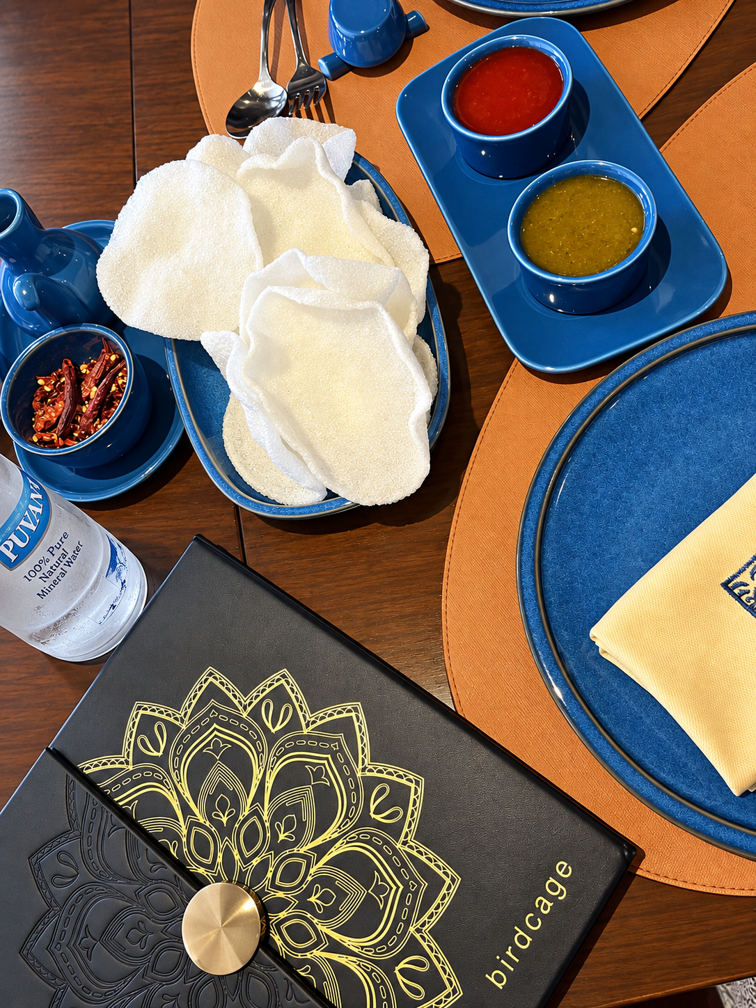 Restaurant table setting with sauces and menu at birdcage at the InterContinental Cairo Semiramis