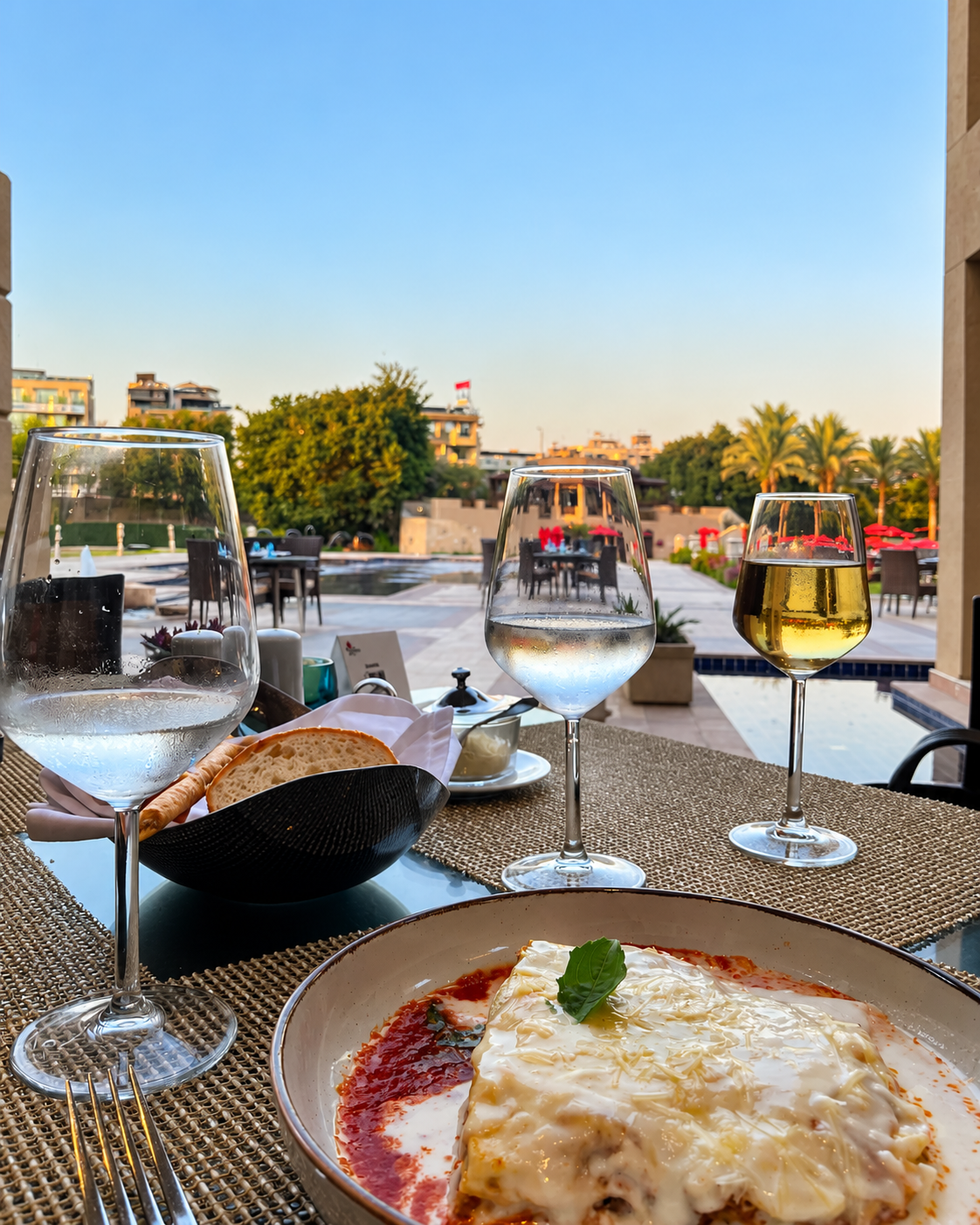 Elegant dining setup with lasagna and wine glasses at Marriott Mena House Hotel