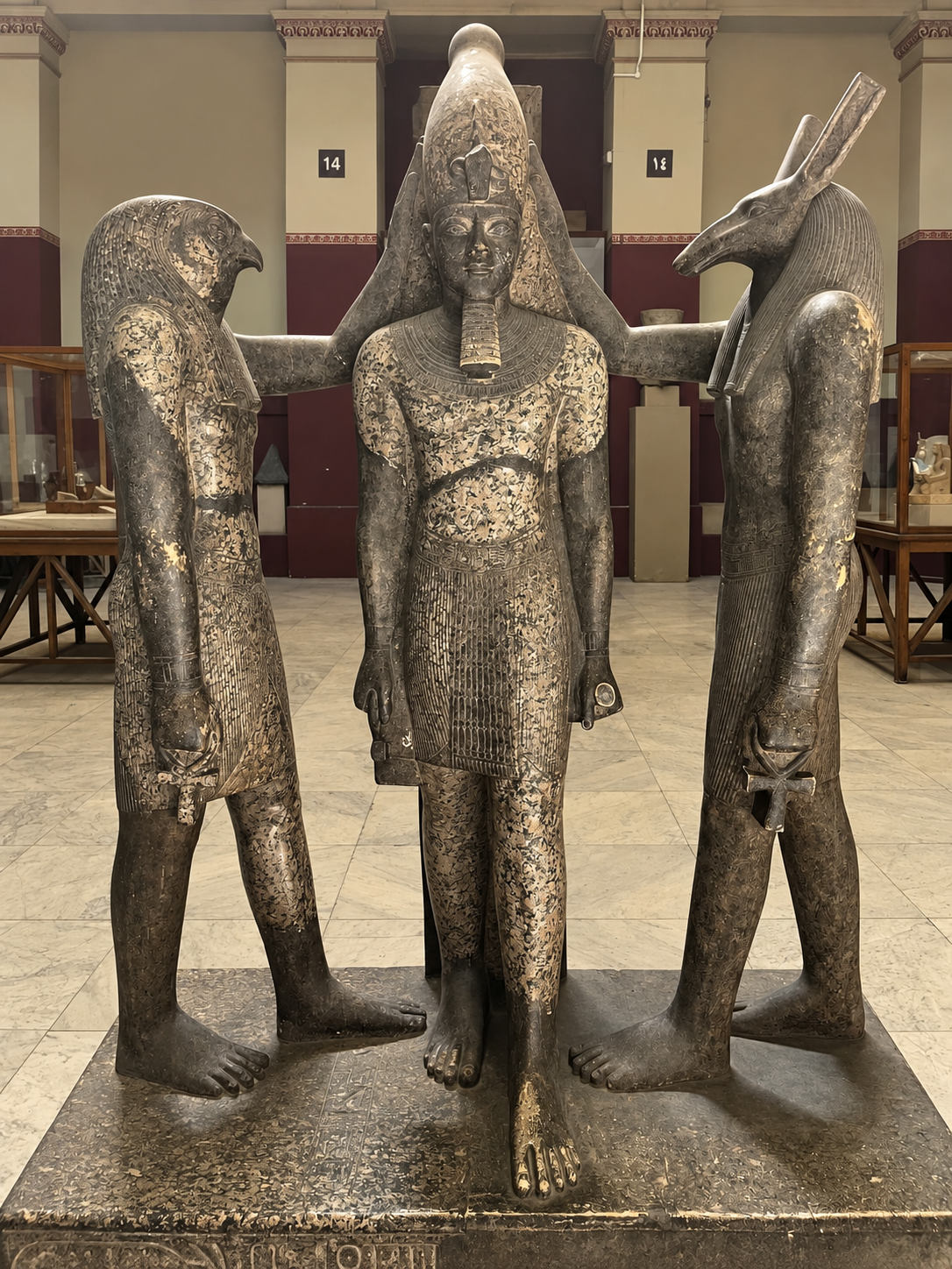 Ancient Egyptian Pharaoh with Horus and Set at the National Museum of Egyptian Civilization in Cairo Ancient Egyptian pharaoh statue flanked by two deities: Horus (falcon head) and Set (animal head) in a museum gallery at the National Museum of Egyptian Civilization in Cairo