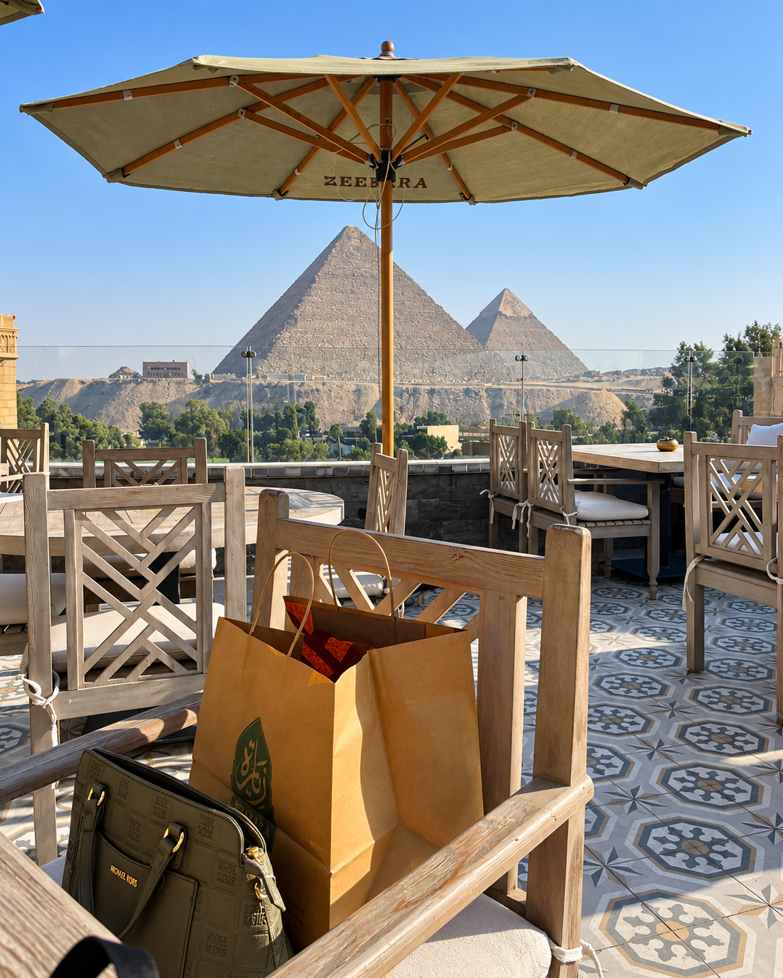 Outdoor seating area at Zeeyara Restaurant with a view of the Pyramids.