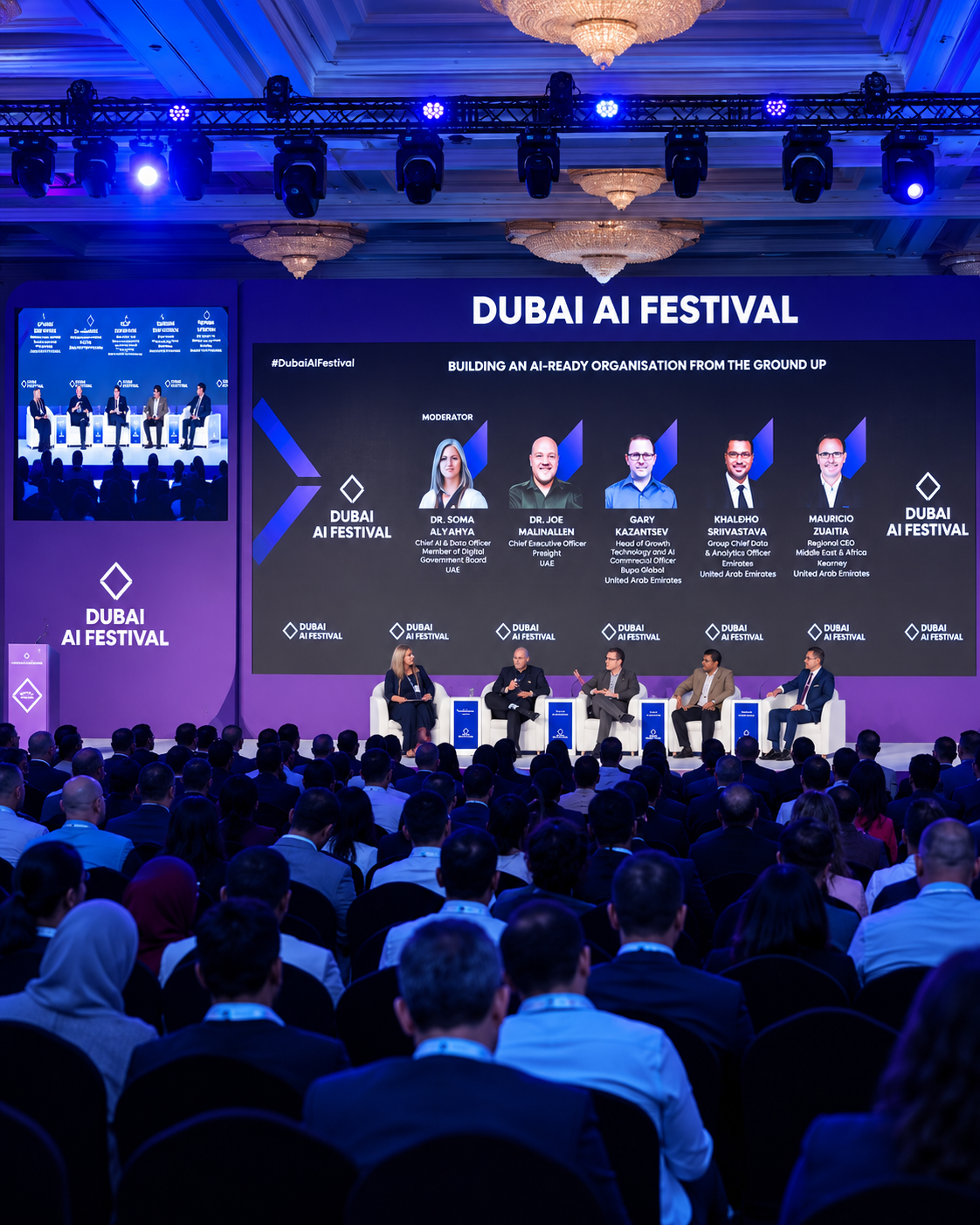 Speakers and moderator conduct a panel discussion at the Dubai AI Festival Panel discussion at Dubai AI Festival with executives and moderator on stage discussing AI-ready organizations
