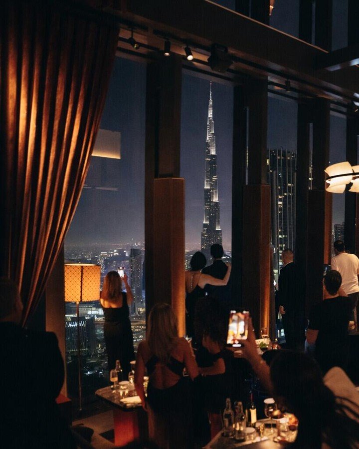 Il Gatopardo Upscale Rooftop Bar with City Views Il Gatopardo upscale rooftop bar with illuminated curtains and cityscape view featuring tall skyscraper at night